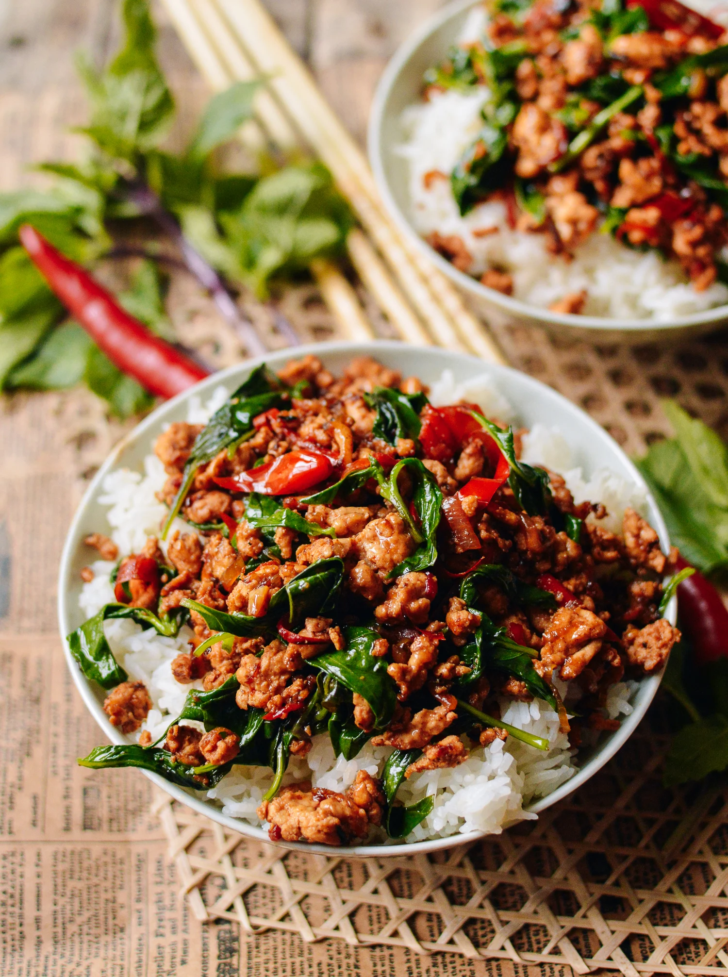 Image of Cooked Spicy Thai Basil Chicken Over Steamed White Rice in a Bowl